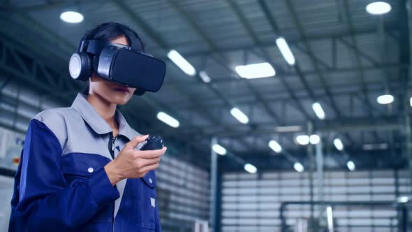 Engineer is using virtual reality glasses to inspect the factory's mechanical control system.