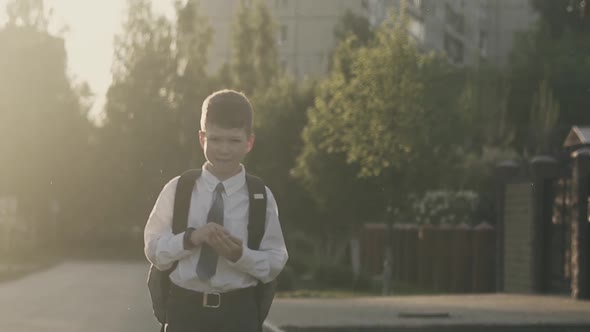 CU, Tracking, Slow Motion: Schoolboy Walks Down the Street and Thinks, Counts on His Fingers.