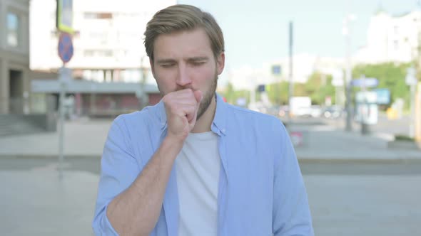 Young Man Coughing While Standing Outdoor