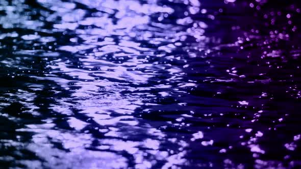 Raining On City Road Surface With Neon Lights Reflected