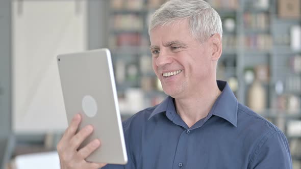 Portrait of Handsome Middle Aged Man Doing Video Chat on Tablet