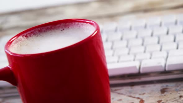 Coffee cup on wooden plank