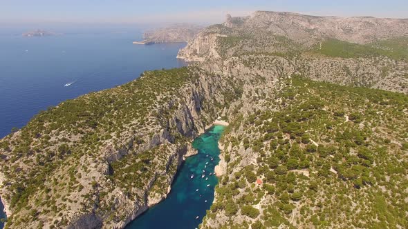 Aerial travel drone view of clear green water, cliffs of Cassis, Mediterranean Sea, Southern France.