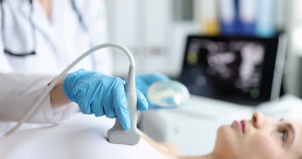 The Surgeon Makes a Breast Ultrasound for a Woman