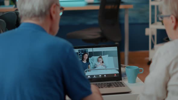 Senior Couple Meeting with Relatives on Online Videocall