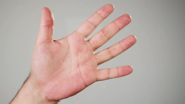 Human Hand Making Fingerprints on Grey Background