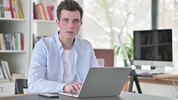 Shocked Young Man Working on Laptop