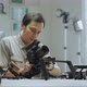  An Asian man is setting a camera rig - VideoHive Item for Sale