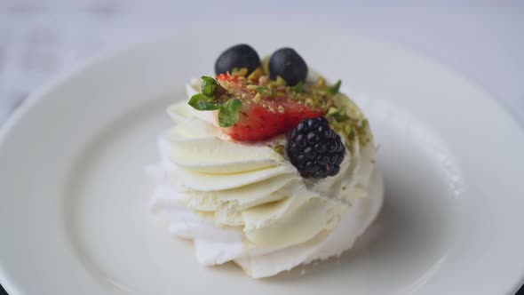 Mini Pavlova Cake meringue dessert with crisp crust and soft inside, rotation