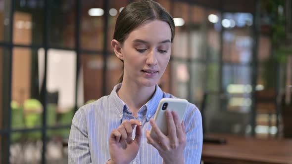 Portrait of Young Woman Using Smartphone