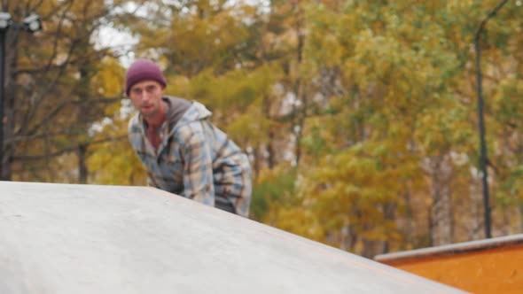 Young Skater Making a Grind on Skatepark During Sunset