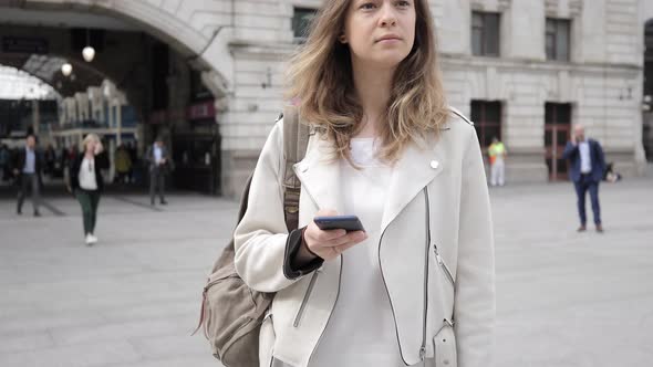 Portrait of a woman checking smartphone, London, UK