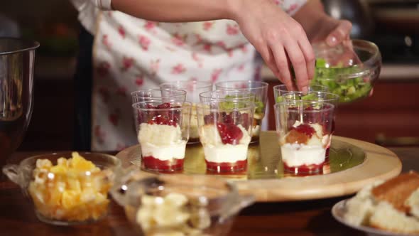 Woman Lays Exotic Fruits in a Dessert