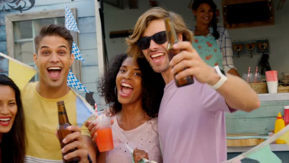 Portrait of happy friends posing with drinks