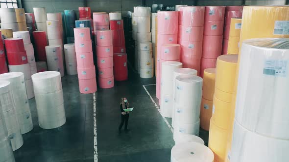 Female Supervisor Is Observing Rolls of Coloured Paper