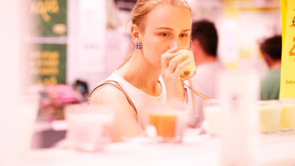 Young Woman Smelling Scented Candles