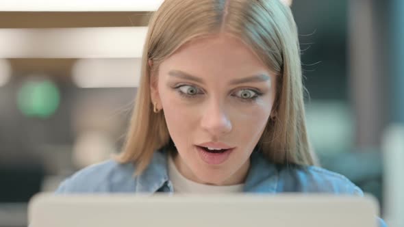 Close Up of Woman Celebrating Success on Laptop