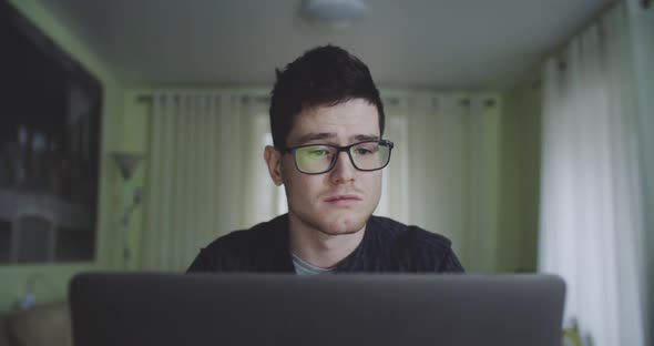 Portrait of Young Male Freelancer Deciding to Resume Working on Laptop at Home