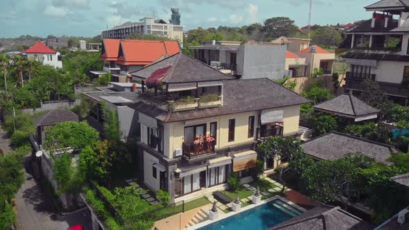 Flight Overlooking the Villa and Girls Near Uluwatu Town on Bali Island Indonesia