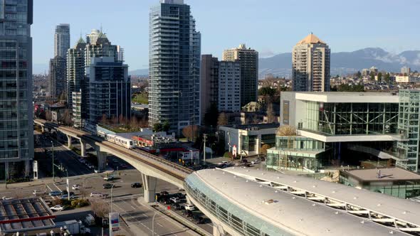 High-rise Buildings In Burnaby City With Train Leaving At Brentwood Town Centre Station In Canada. -