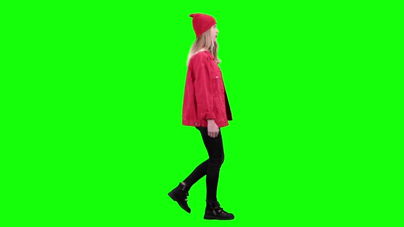 Girl Is Walking Down the Street and Flirting with Others. Green Screen. Side View