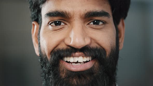 Close Up Male Arabian Bearded Face Handsome Man with Bright Brown Eyes Looking at Camera Smiling