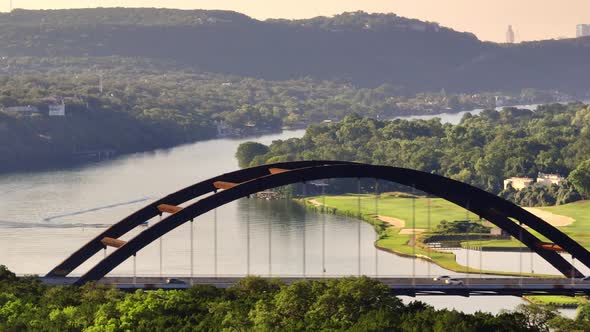 Aerial sweep of 360 Pennybacker bridge and Austin Country club overlooking Lake Austin with zoomed i