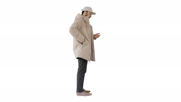 Man in Winter Clothes Using Sanitizer Spray To Prevent Flu Disease on White Background