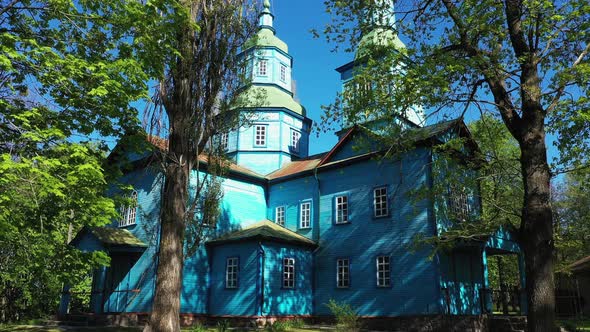 Wooden Church Surrounded by High Old Trees