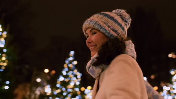 Happy Young Woman in Christmas City in Winter
