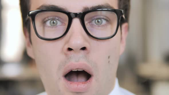 Close Up of Wondering Man Face in Glasses Shock