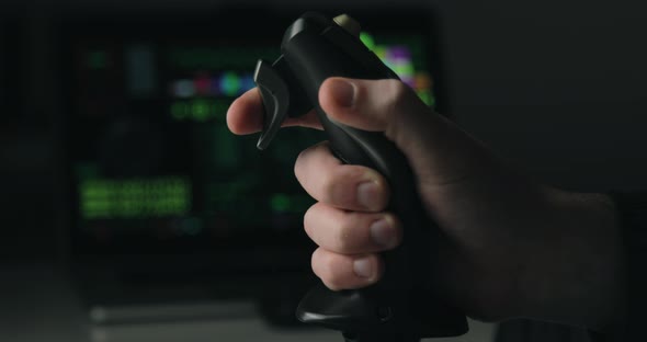 Hand of a Military Pilot Controls a Remote Spy Surveillance Drone for Warfare