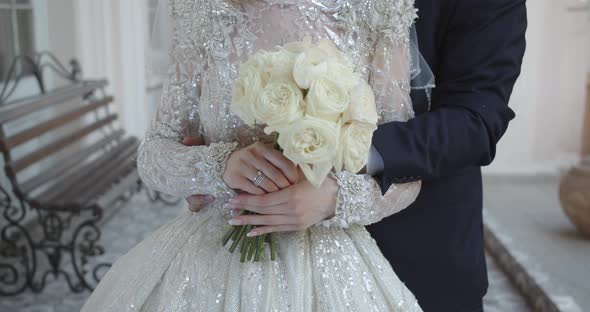 The Groom Gently Hugs The Bride By The Waist