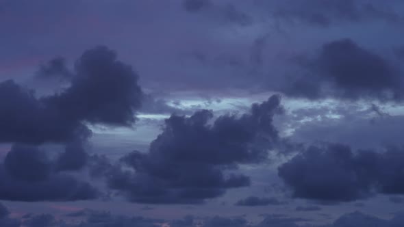 Timelaps of the Evening Blue Sky with Purple Clouds Floating Across the Sky Bright Flashes of