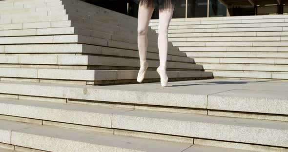 Female ballet dancer performing on stair 4k