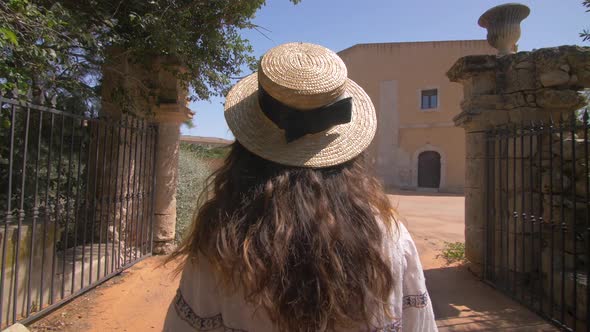 Beautiful woman walking near old luxury villa in Italy