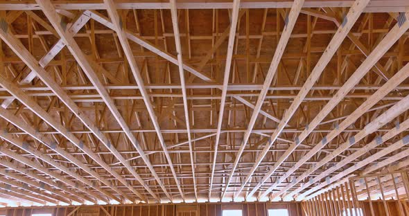 Builder Roof Trusses on Roof of New House Residential Building Under Construction