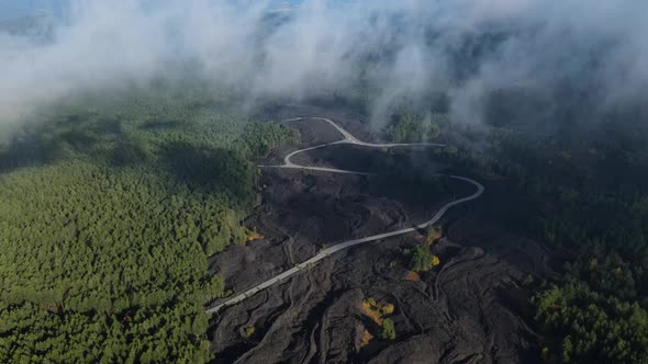 A road up a volcano covered in low clouds