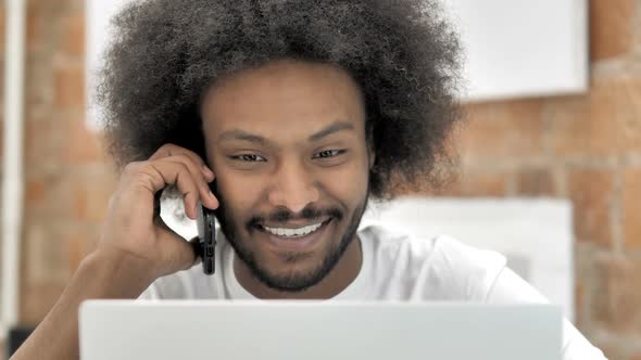 African Man Talking on Phone