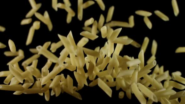 Penne Pasta Flies After Being Exploded Macaroni Before Preparation Bouncing and Falling Down