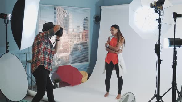 Professional Photographer Asking Model To Change Poses While Make a Photo Shoot in Studio