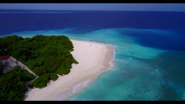 Aerial drone shot landscape of exotic tourist beach journey by turquoise lagoon with clean sandy bac
