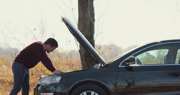 Caucasian Man Opens the Hood of the Car for Checking Problem of Broken Car