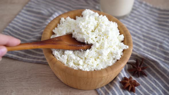 Traditional homemade cottage cheese in a wooden bowl Healthy and fermented food