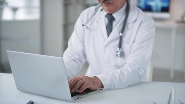 Joyful Medical Worker Using Laptop