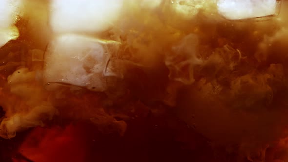 Super Slow Motion Shot of Pouring Cream or Milk Into Ice Coffee Whirl at 1000Fps alt