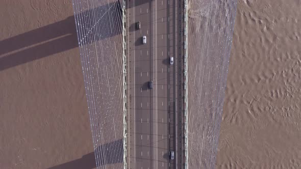 Vehicles in the UK Driving Across a Suspension Bridge Aerial View