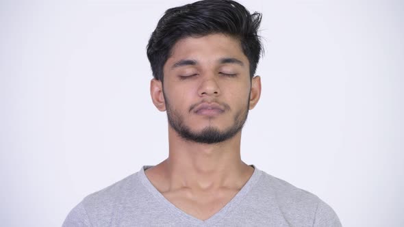 Young Happy Bearded Indian Man Relaxing with Eyes Closed