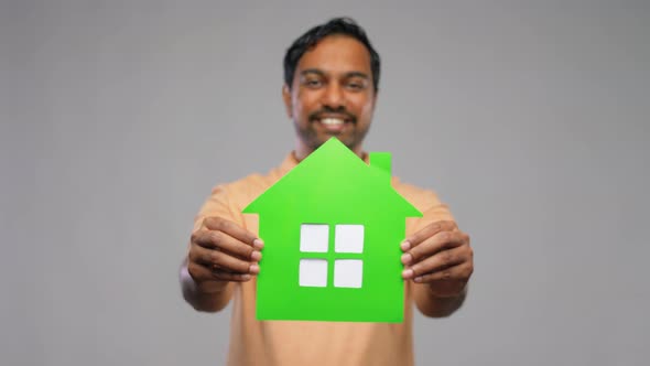 Smiling Indian Man Holding Green House Icon