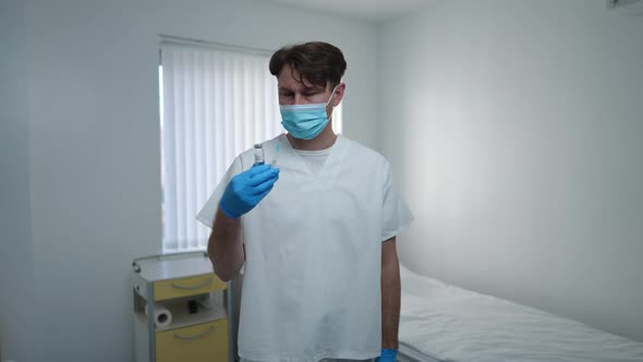 Medium Shot Serious Doctor in Face Mask and Uniform with Coronavirus Vaccine Stretching Hand Shaking